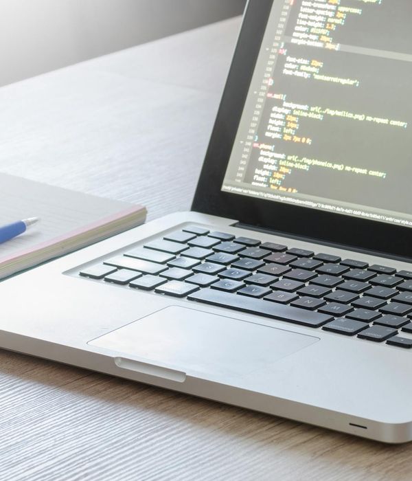 modern web development workspace with laptop and code